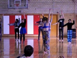 Students learning some Hula movements from 'KITH'.